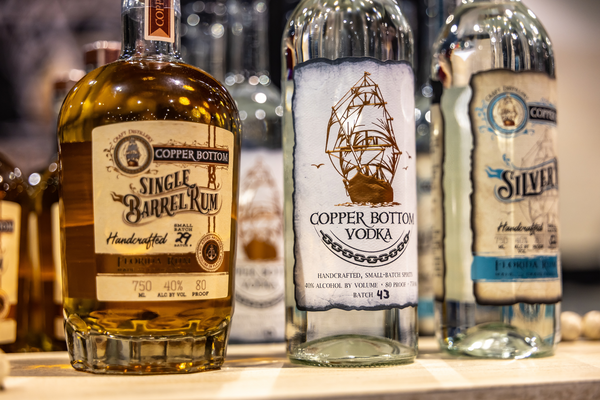 Copper Bottom Craft Distillery's Single Barrel Rum and Vodka bottles on display at the Florida Saltwater Fishing Expo.