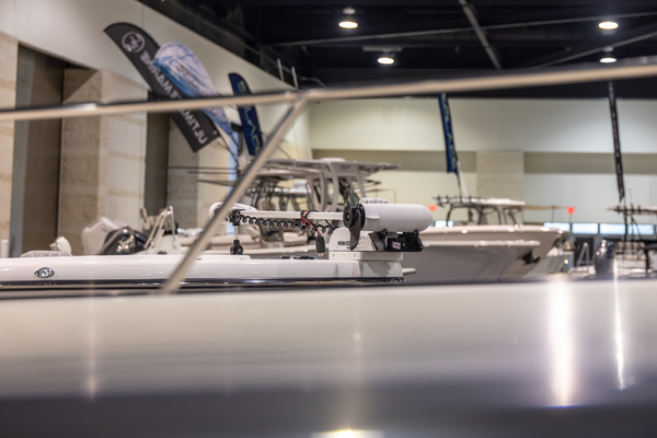 Center console boats rigged with Minn Kota trolling motors line the show floor at the Florida Saltwater Fishing Expo.