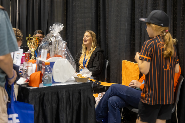 A raffle table with a trophy and gift basket draws smiles from attendees at the Florida Saltwater Fishing Expo.