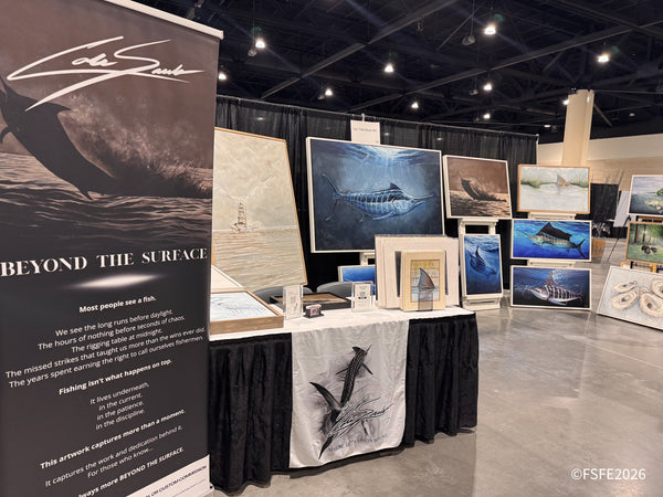 Marine art on display from Capt. Cole Sauls Art at the Florida Fishing Expo, featuring hand-painted marlin and redfish pieces.