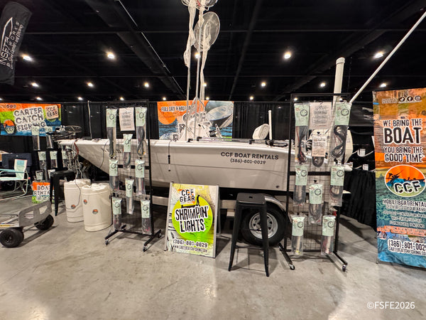 Carter Catch Fishing's CCF Boat Rentals booth at the Florida Fishing Expo showcases a rigged center console and shrimping light gear.