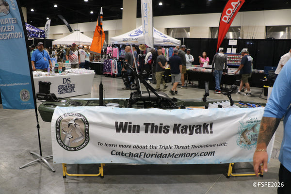 A packed aisle of anglers browses DS Custom Tackle and Salty Hunters near the FWC kayak giveaway at the Florida Fishing Expo.