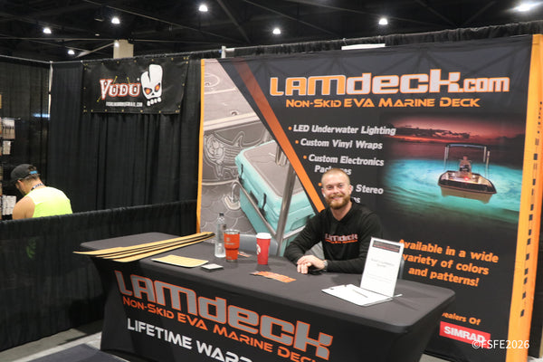 A smiling LAMdeck.com rep sits ready to talk non-skid marine decking at the Florida Fishing Expo.