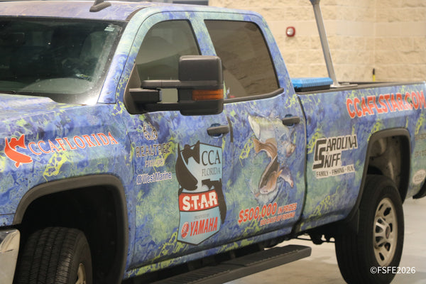 A CCA Florida STAR tournament truck wrap featuring Yamaha, West Marine, Realtree, and Carolina Skiff parked at the Florida Fishing Expo.
