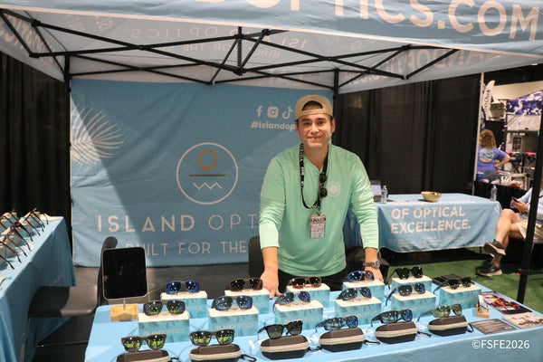 A smiling Island Optics team member showcases their polarized sunglasses lineup at the Florida Fishing Expo.