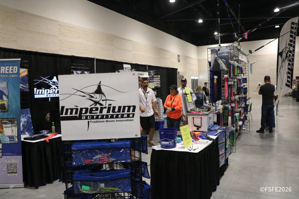 Imperium Outfitters staff chat with visitors under their 'Tradition Meets Innovation' banner at the Florida Fishing Expo.
