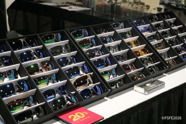 A Costa sunglasses display glints under the lights at the Florida Fishing Expo, with select styles marked 20% off.