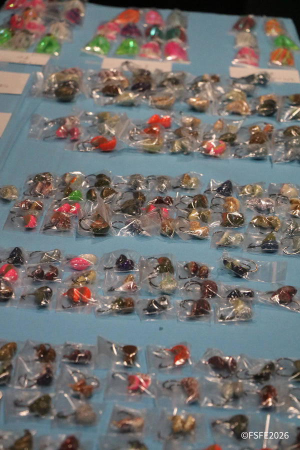 Rows of colorful jig heads packaged for sale, a close-up look at tackle available at the Florida Fishing Expo.