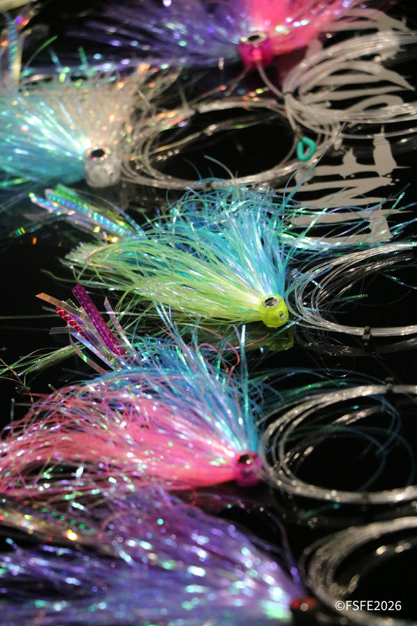 Close-up of colorful hand-tied saltwater fishing jigs on display at the Florida Fishing Expo.