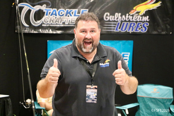 A Gulfstream Lures vendor flashes an ecstatic double thumbs-up in front of the Tackle Crafters banner at the Florida Fishing Expo.