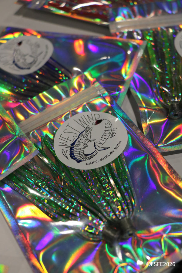 A close-up of shimmering West Wind Witches trolling lures by Capt. Shelby Zona, on display at the Florida Fishing Expo.