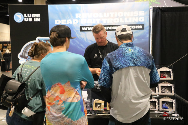 Attendees get a hands-on demo of dead bait trolling lures at the Lure Us In booth during the Florida Fishing Expo.