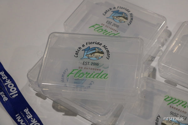 Clear "Catch a Florida Memory" tackle boxes, a popular giveaway item spotted at the Florida Fishing Expo.