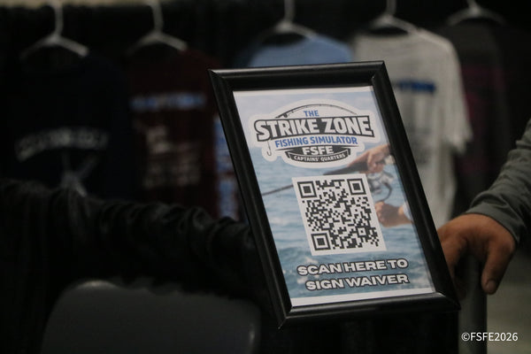 A sign for The Strike Zone Fishing Simulator invites Florida Fishing Expo guests to scan in and try their luck in the Captains' Quarters.
