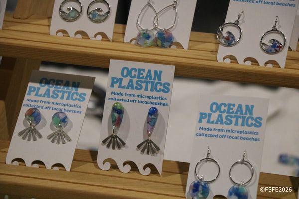 Handmade Ocean Plastics earrings crafted from microplastics collected off local beaches, on display at the Florida Fishing Expo.