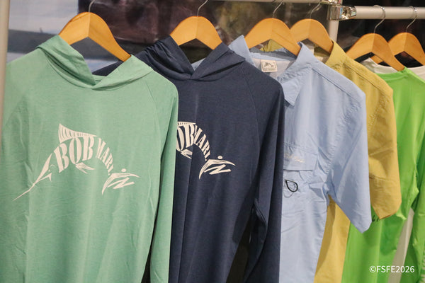 A rack of colorful Bob Marlin hooded shirts and fishing apparel for sale at the Florida Fishing Expo.