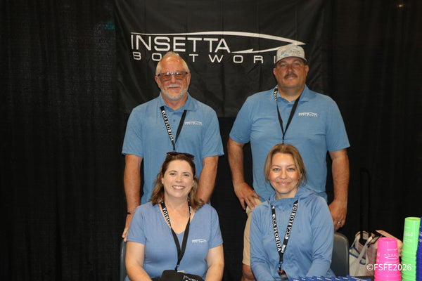The smiling Insetta Boatworks team poses together at their Florida Fishing Expo booth.