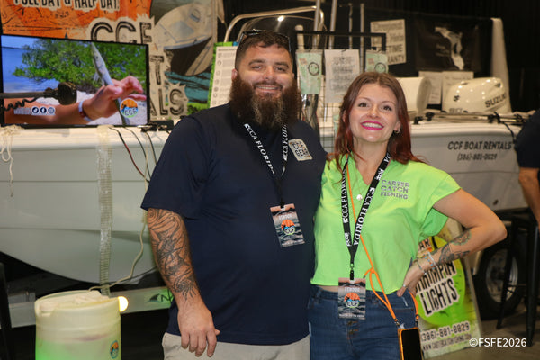 Carter Catch Fishing's husband-and-wife team beam in front of their CCF Boat Rentals display at the Florida Fishing Expo.