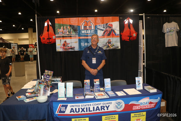 A friendly U.S. Coast Guard Auxiliary volunteer staffs the Boat Responsibly safety table at the Florida Fishing Expo.