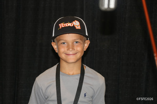 A grinning young angler shows off his Vudu cap at the Florida Fishing Expo.