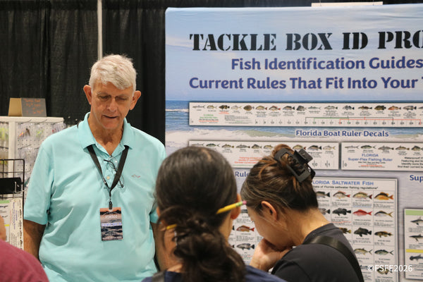 The Tackle Box ID vendor chats with attendees about Florida fish identification guides at the Florida Fishing Expo.