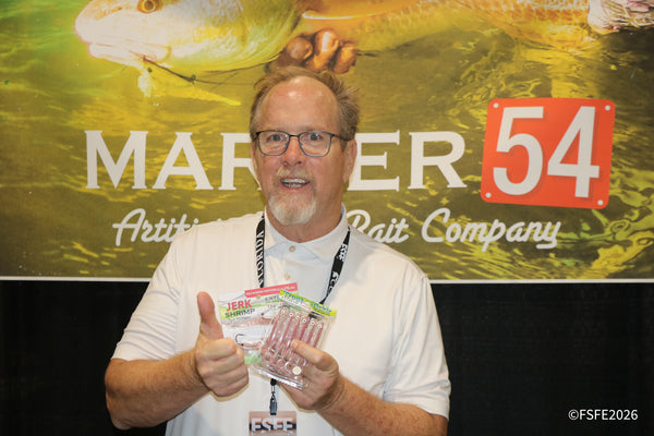 A Marker 54 Bait Company rep gives a thumbs-up while showing off their Jerk Shrimp lures at the Florida Fishing Expo.