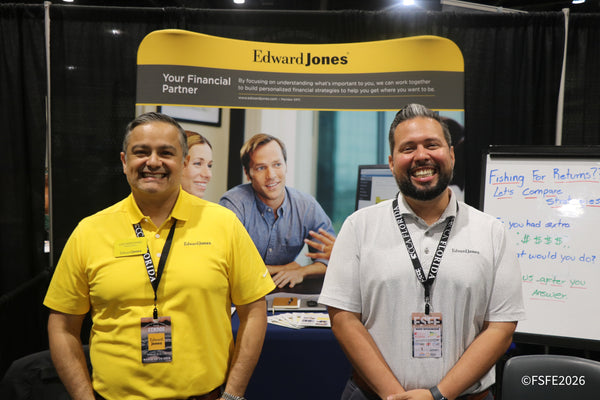 Edward Jones financial advisors laugh together at their 'Fishing for Returns' themed booth at the Florida Fishing Expo.
