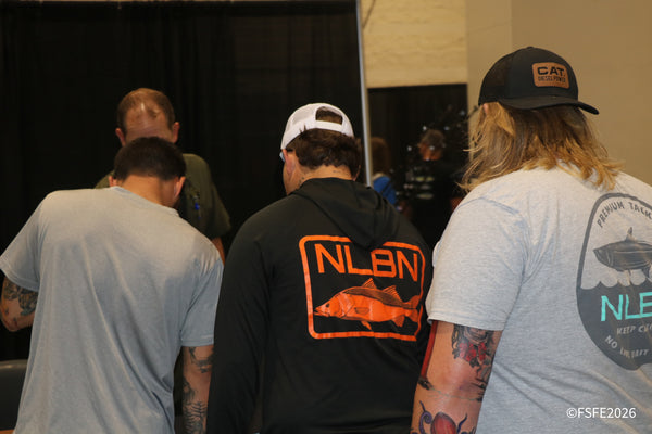 Attendees in NLBN 'No Live Bait Needed' gear make their way through the Florida Fishing Expo show floor.