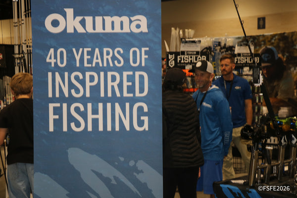 Attendees gather at the Okuma booth, marking "40 Years of Inspired Fishing" on the show floor at the Florida Fishing Expo.