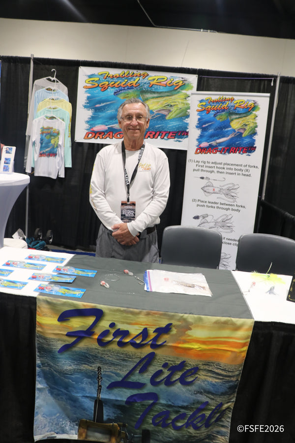 A First Lite Tackle vendor smiles beside his Drag-It Rite trolling squid rig display at the Florida Fishing Expo.