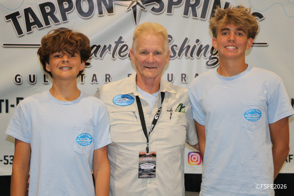 A charter captain from Gulfstar Endurance Fishing Charters in Tarpon Springs smiles alongside two young anglers at the Florida Fishing Expo.