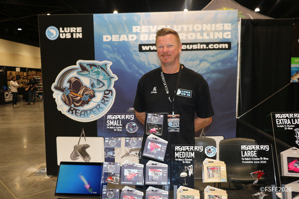 The Lure Us In vendor stands proudly with his full Reaper Rig dead-bait-trolling lure lineup at the Florida Fishing Expo.