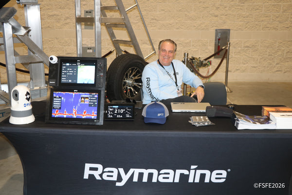 A smiling Raymarine rep showcases marine electronics and fish-finding displays at the Florida Fishing Expo.