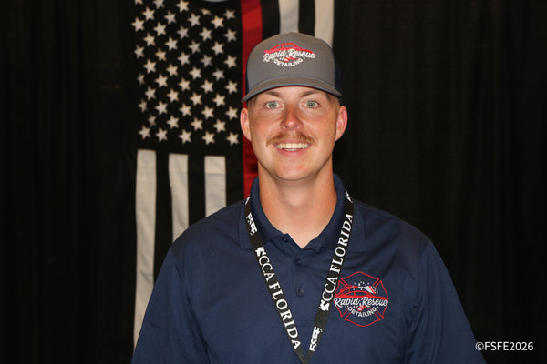 A CCA Florida-lanyard attendee wearing a Rapid Rescue Detailing hat smiles for a portrait at the Florida Fishing Expo.